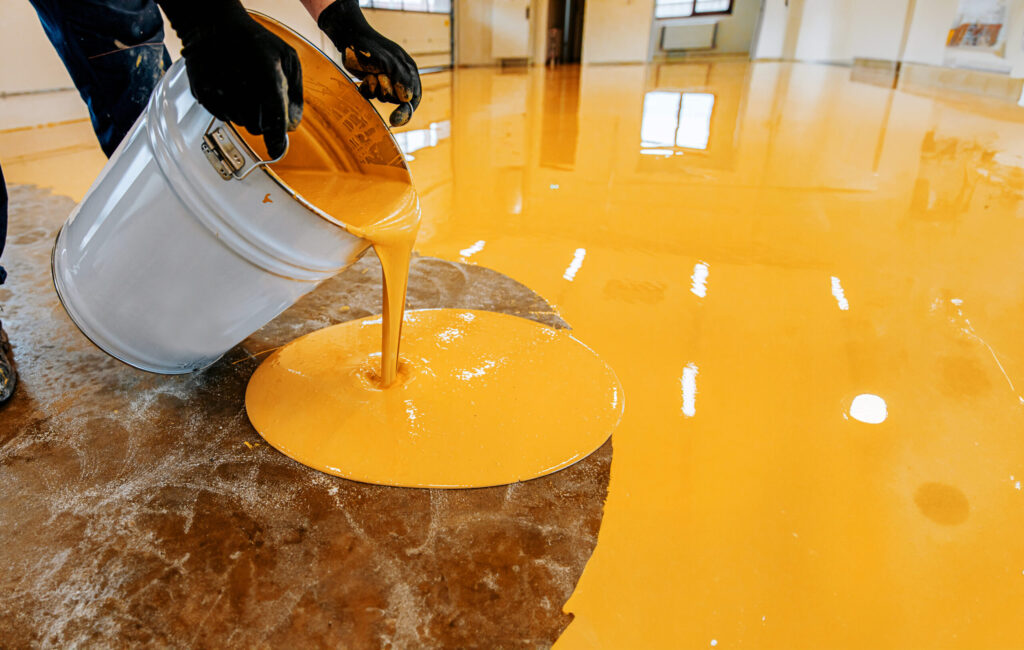 a person pouring liquid into a bucket on an orange 2023 12 20 22 40 09 utc 1 scaled